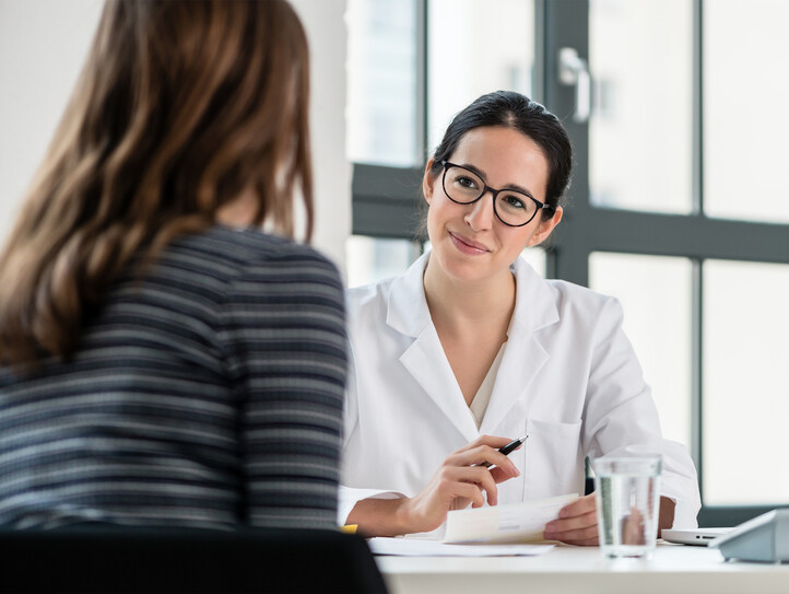 Female physician listening to her patient during consultation